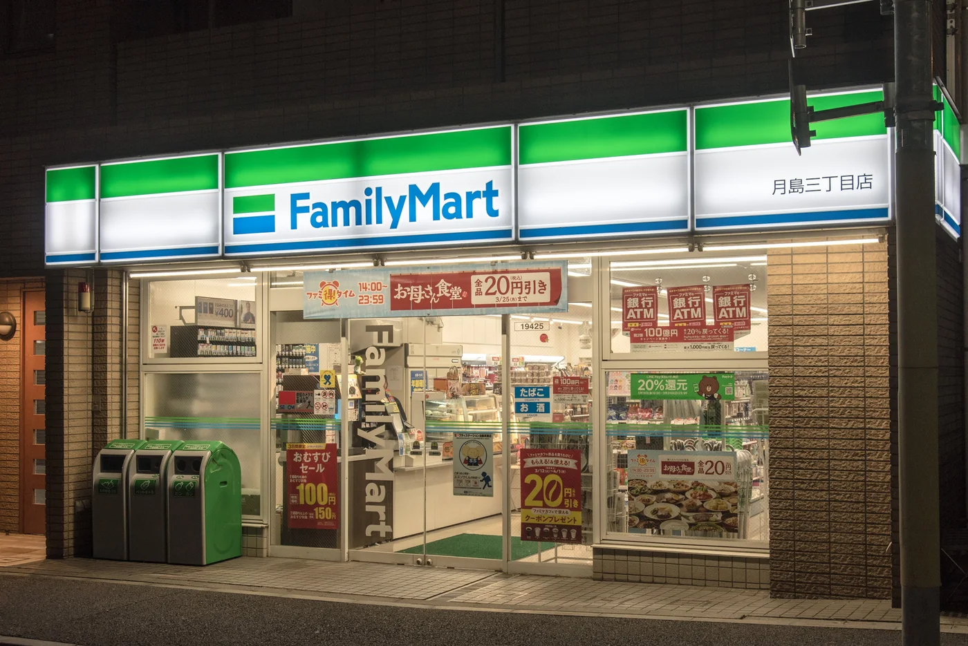 Fachada iluminada de uma loja FamilyMart em Tsukishima, Tóquio.